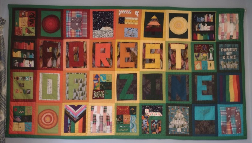 finished Forest of Zine quilt hanging on wall in my house